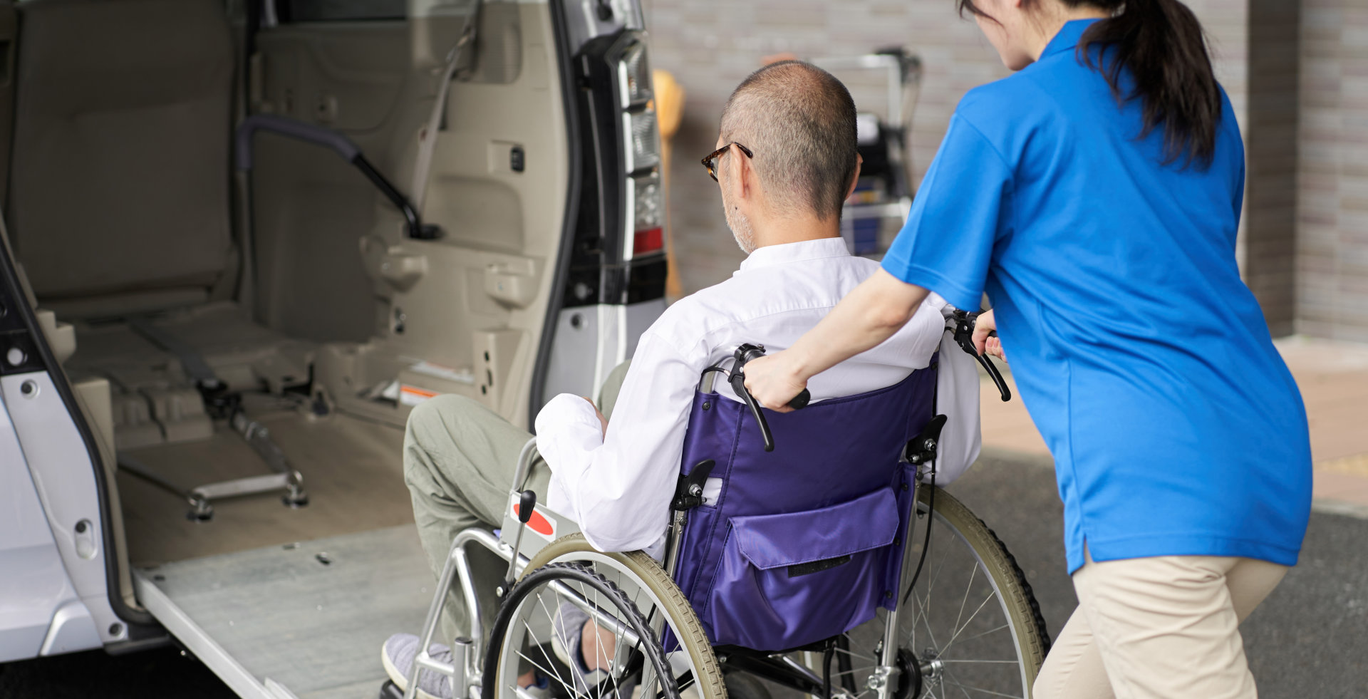 caregiver assisting senior to vehicle