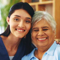 caregiver and senior smiling