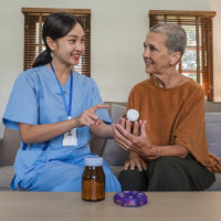 caregiver reminding senior of medication