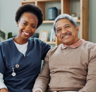 african caregiver and elderly man