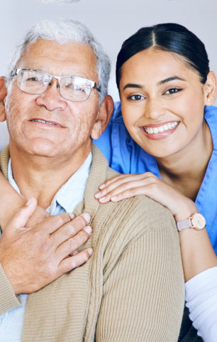 caregiver and elderly man smiling